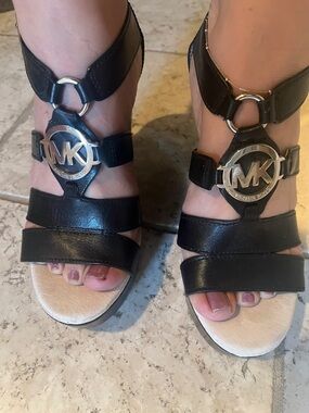 Michael Kors Black Leather Logo T-Strap Sandals with Silver MK Emblems